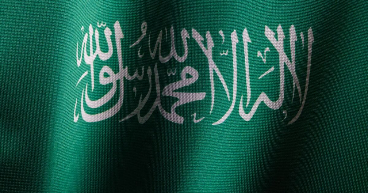 Detailed close-up of the Saudi Arabian flag showcasing the elegant Arabic script and vibrant green color.