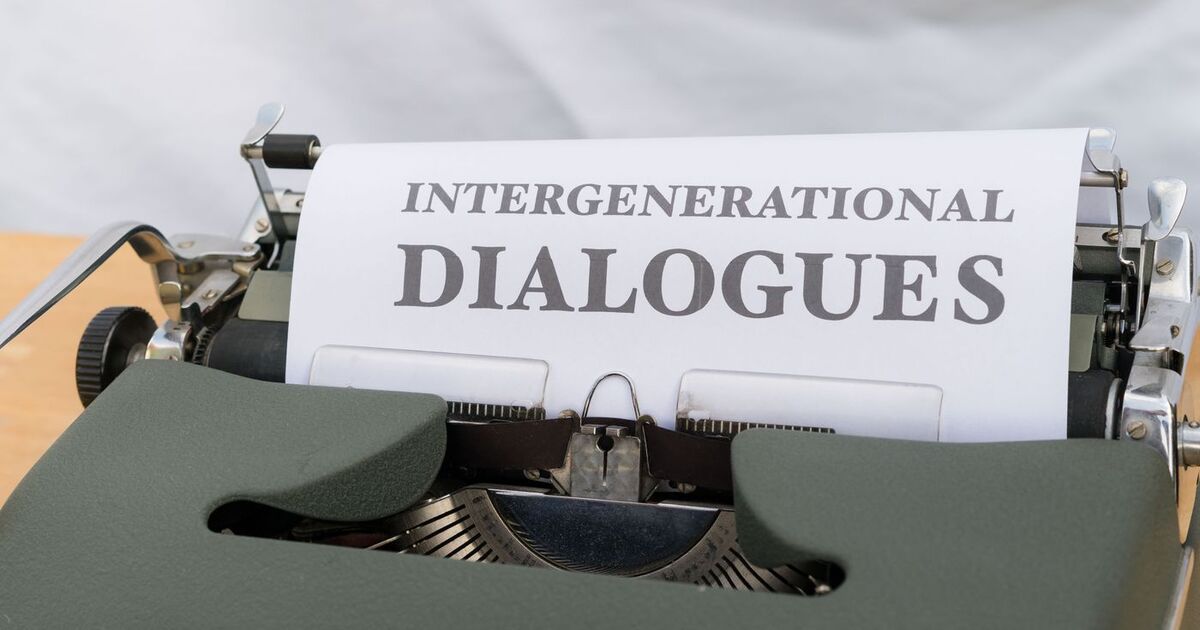 Close-up of a vintage typewriter with a sheet labeled 'Intergenerational Dialogues.'