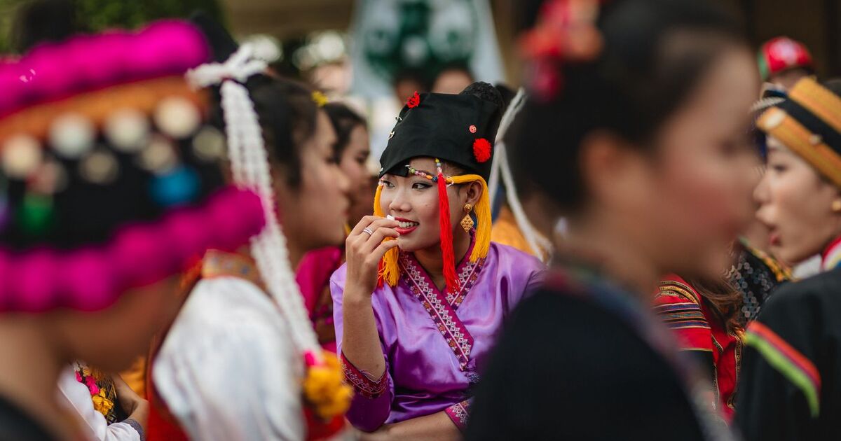 Colorful festivities at an Asian festival in Vientiane, Laos, showcasing traditional attire and cultural gathering.