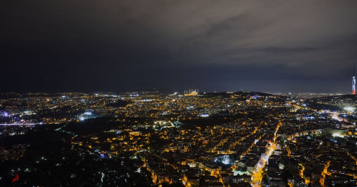 A captivating night aerial view of Istanbul's illuminated skyline with iconic landmarks visible.