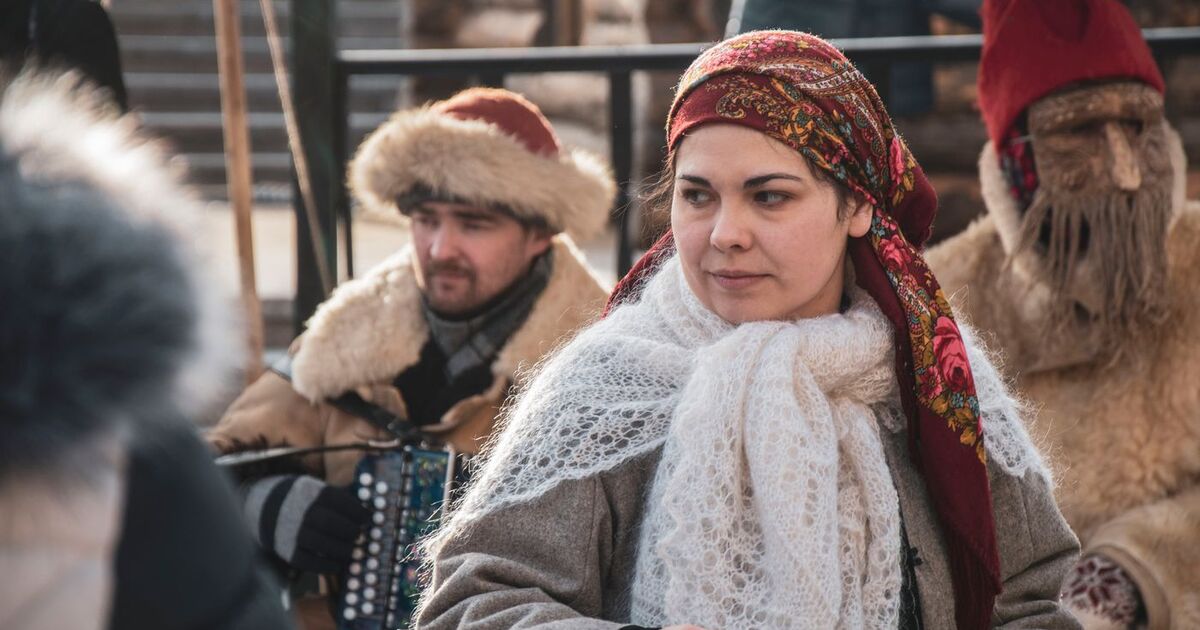 Celebrate Russian culture at a vibrant winter festival in Moscow with traditional clothing and music.