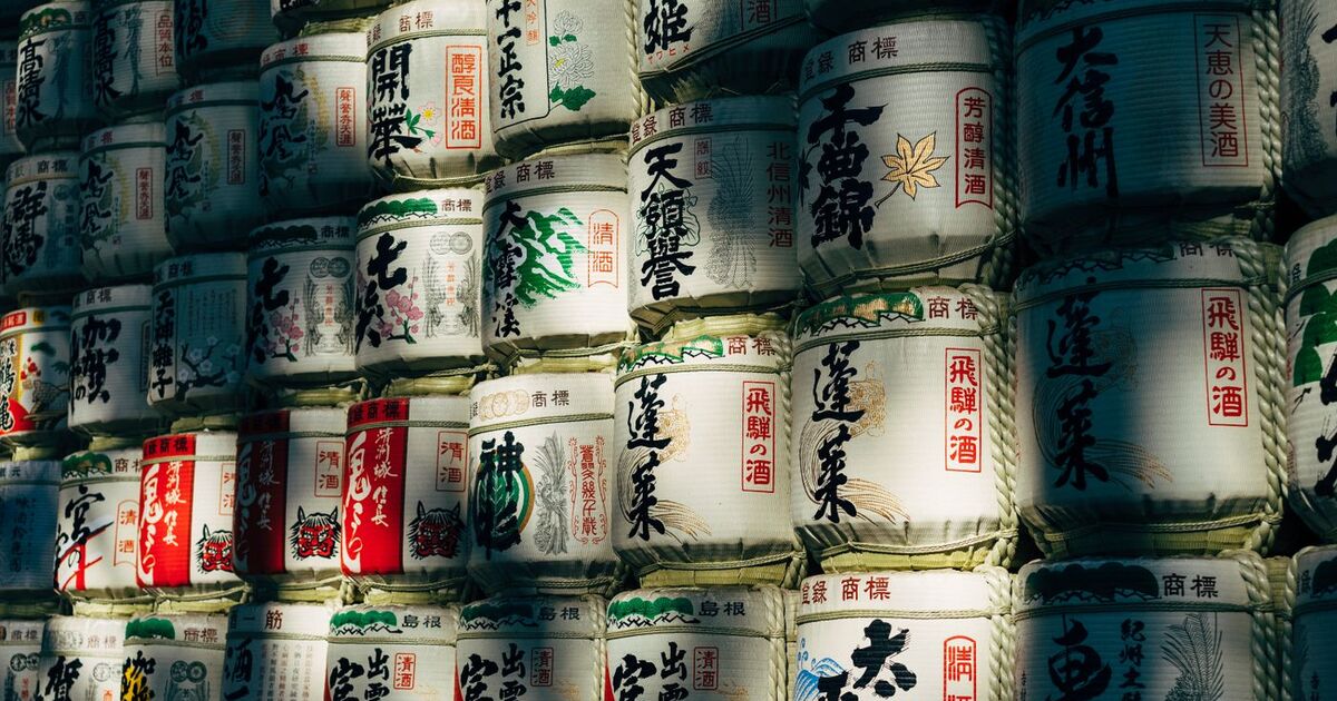 A wall of traditional sake barrels in Shibuya City, Tokyo, showcasing Japanese culture.